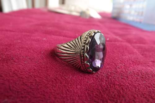 Bulky silver toned ring with oval purple stone.Size 9.5.rhodium plated.New