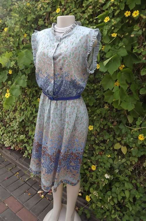 Light grey sleeveless vintage dress with blue/beige and red floral borders.Size 42/18.