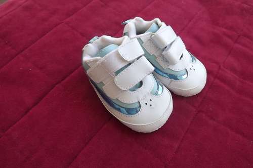 Pair of white and blue first baby sneakers.As new