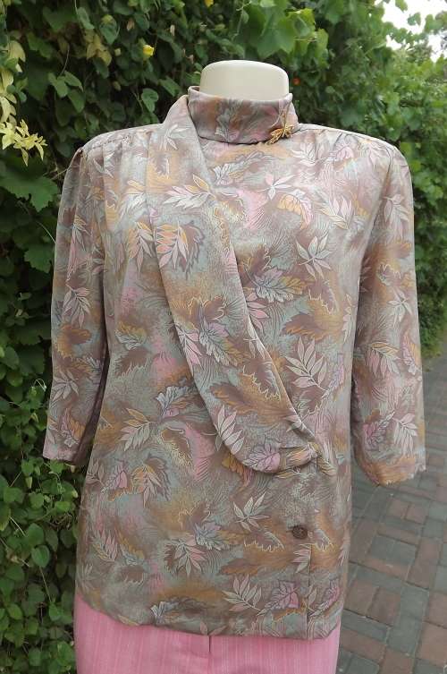 Uniquely styled blouse/top in silky polyester fabric.Fold over front with one sided collar.