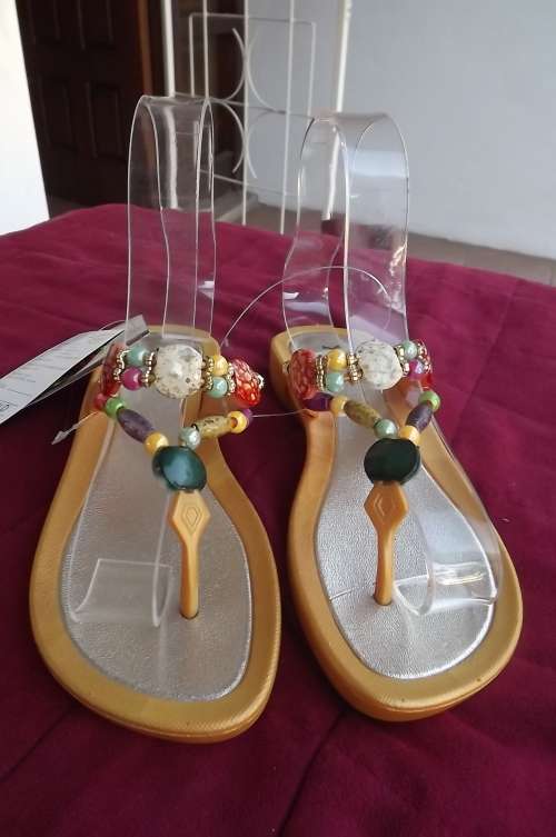 Pair of sandals by XRT. Size 37/4.Gold colour with colourfull beads.Soft and bendable.