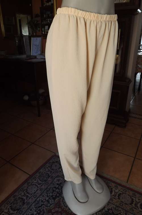 Comfortable creased polyester pants in soft peach colour.Size 40/16 .As new