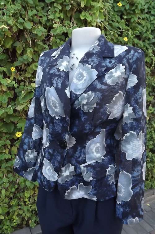 Cutting edge blue/black tailored jacket with bold silvergrey flowers.Size 36/12.Boutique sample.
