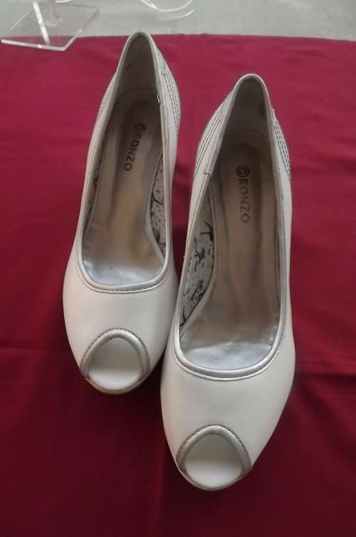 Pair of white open toe wedge heel shoes with silver by RENZO size 6.Used but in good condition.