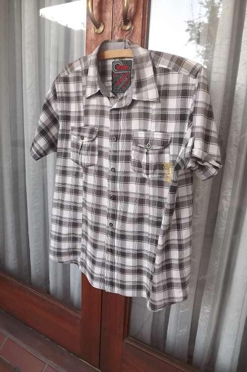 Stylish casual brown check polycotton shirt.Size Large.Chest 108cm.Fold over short sleeves.