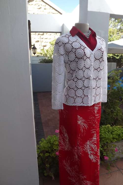State of the art white crocheted long sleeve cardigan.Size 35/11.Done in cotton yarn