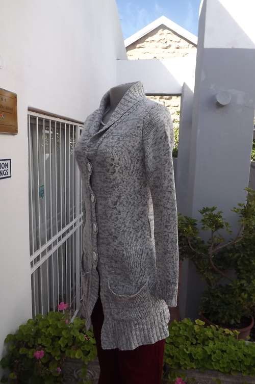 Versatile long mottled grey cardigan.Size 32/8.Button down with front pockets.