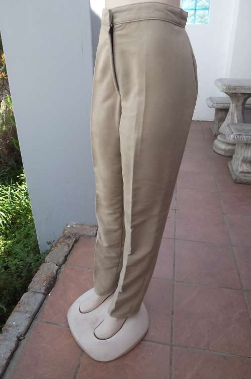 Beige suede look pants with high waist.Two pockets at back.Size 38/14.New condition.