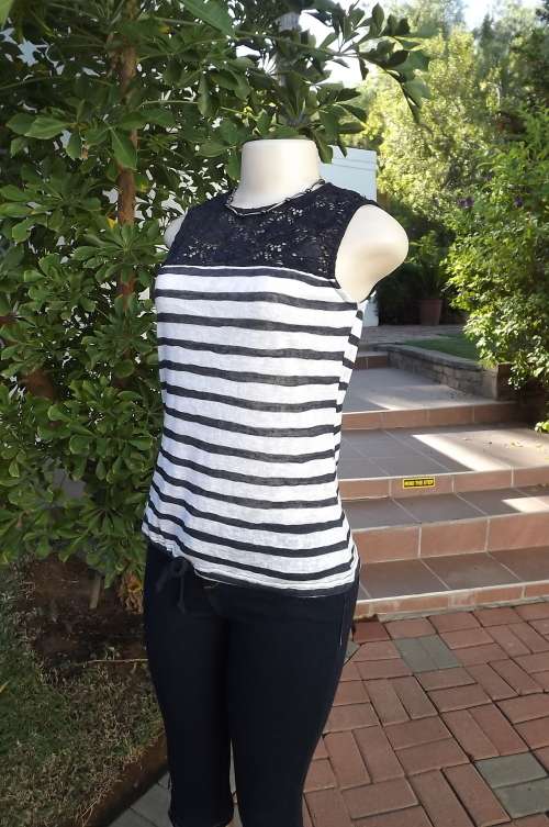 Cool and breezy LtD sleeveless top in navy and white.Size 32/8.Top area navy acrylic lace fabric