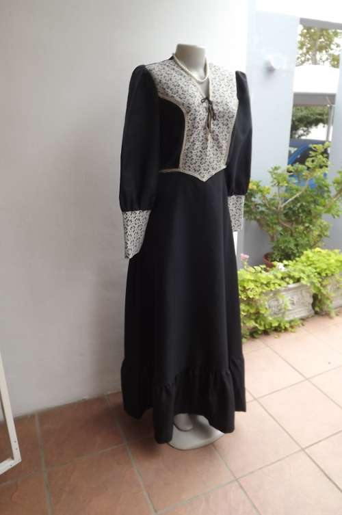 Black silky polyester maxi dress with wide frilled seam.Size 36/12.Good condition.