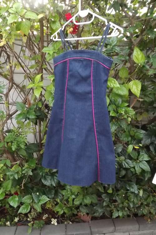 Beautiful blue denim strappy dress with pink satin binding.For 8 to 9 year old.By LOX.As new
