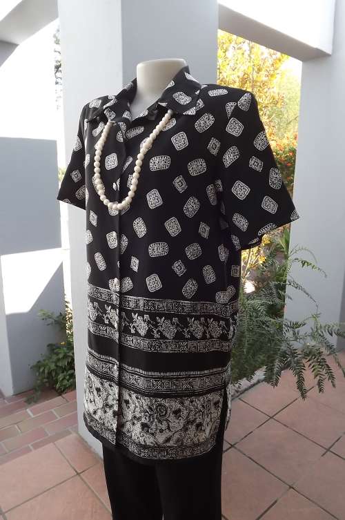 Black long button down top/jacket with cream design  beautiful graphic border.Size 38/14.
