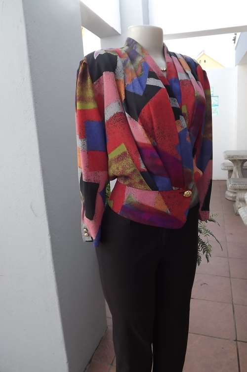 Try a burst of bright warm colours.Cross over front cropped top.Size 36/12.Fronts pleated.