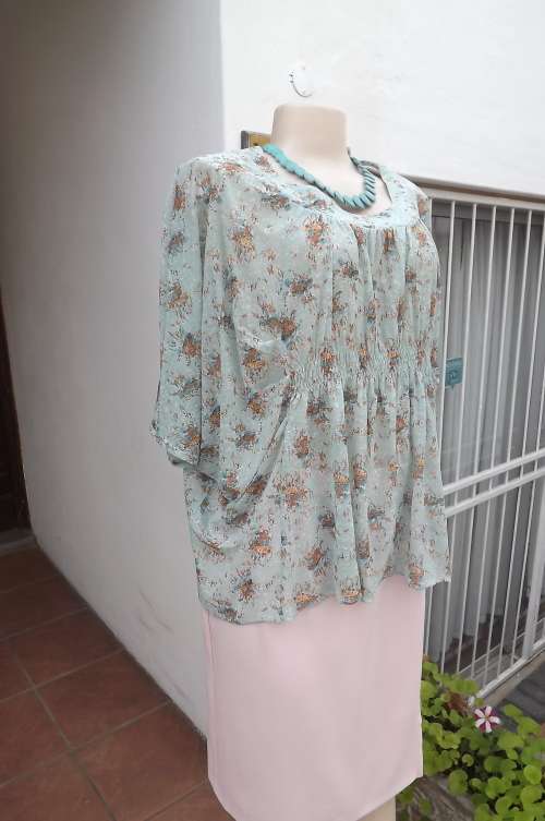 Loose light turquoise floral top in polyester/nylon blend by PQ,Will fit 34 to 38.New item