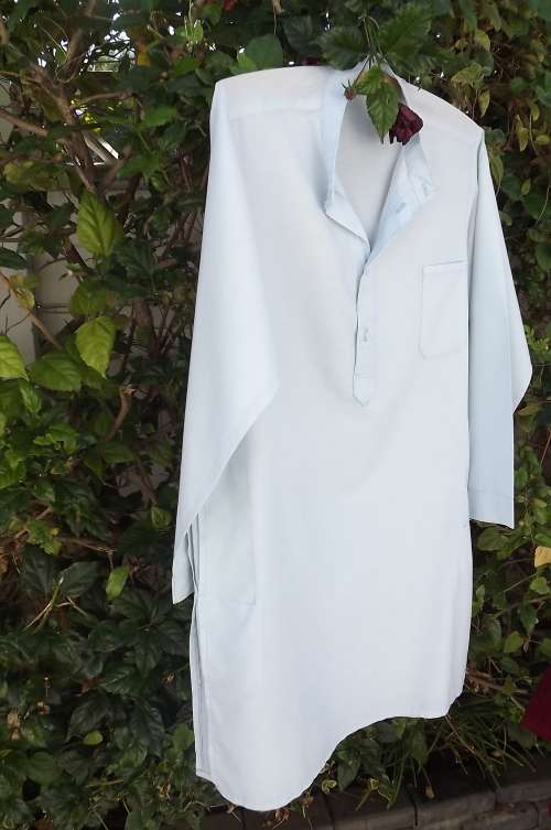 Men`s long shirt with chinese collar.side pockets and slits Soft blue polycotton.Chest 108cm Size M