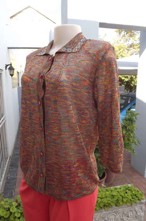 Soft acrylic knit top/cardigan.In rainbow colours. Patterned .Partly see-through.Size 38/14