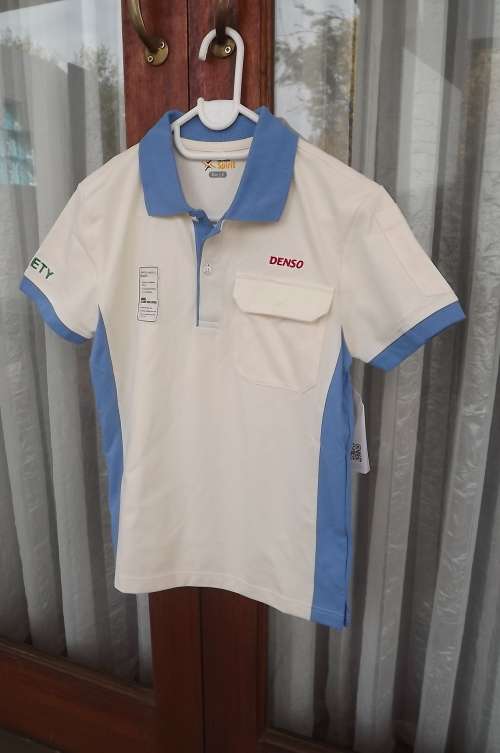 Denso Spirit golf shirt  in cream with blue trimming.Polycotton fabric. 12 to 13 year old. New item