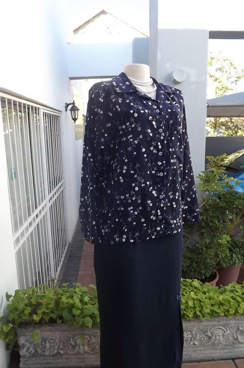 Boutique made navy floral blouse in heavy polyester.Size 37/13.Small flower pattern.As new