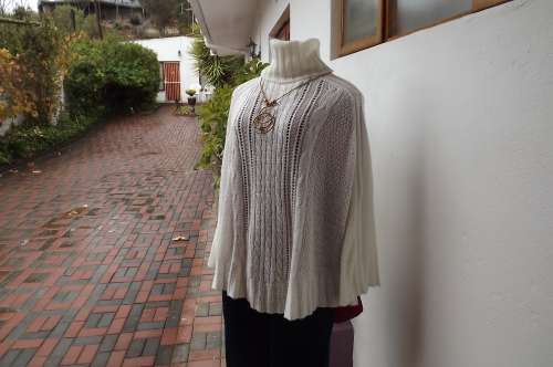 Soft cream short knitted cape with poloneck.Cable knit on front.Fit 34 to 38.