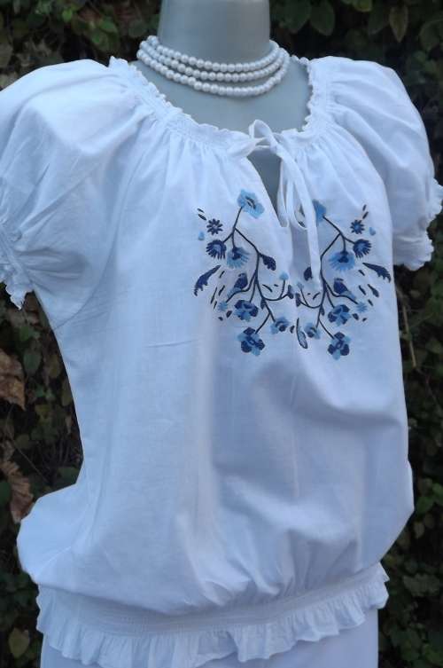 White cotton blouson style blouse with elasticated round neckline,seam and sleeve cuffs