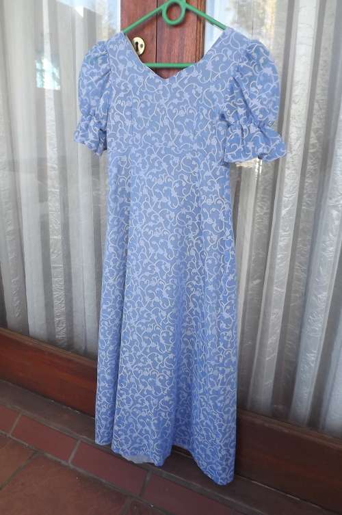 Boutique made sheer blue dress with embossed floral pattern.Fully lined.Size for 7 to 8 year old