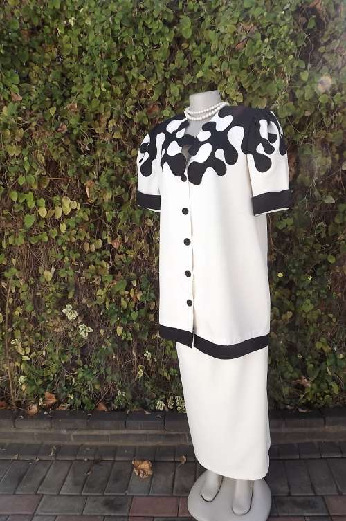 Individualistic cream 2 piece skirt outfit with black decoration.Boutique made.Size 38/14