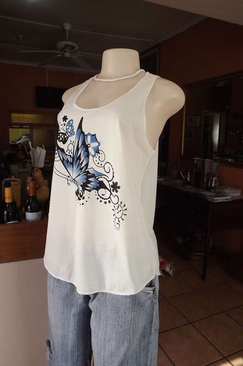 Pretty vest style 100% polyester top with large blue/black butterfly design and rounded seam