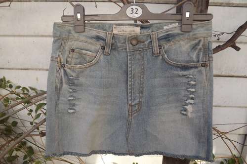 Chic light blue denim mini skirt with distressed look.Pockets back and front.Size 31/1 by MINI BIKE