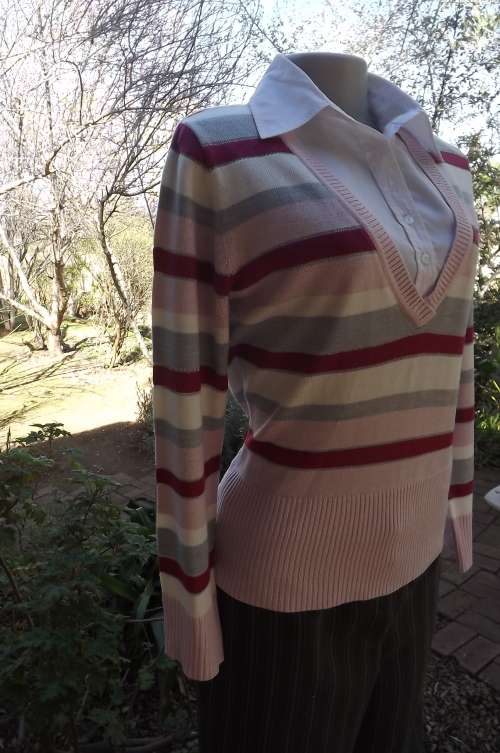 Chic knitted top in pinks,grey and white stripes with silver glitter.V front with button down front.