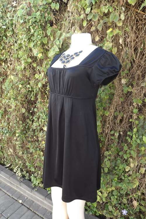 Comfy little black dress in stretch polyester by NOSTALGIA.Size 33/9.Capped sleeves.Square neckline
