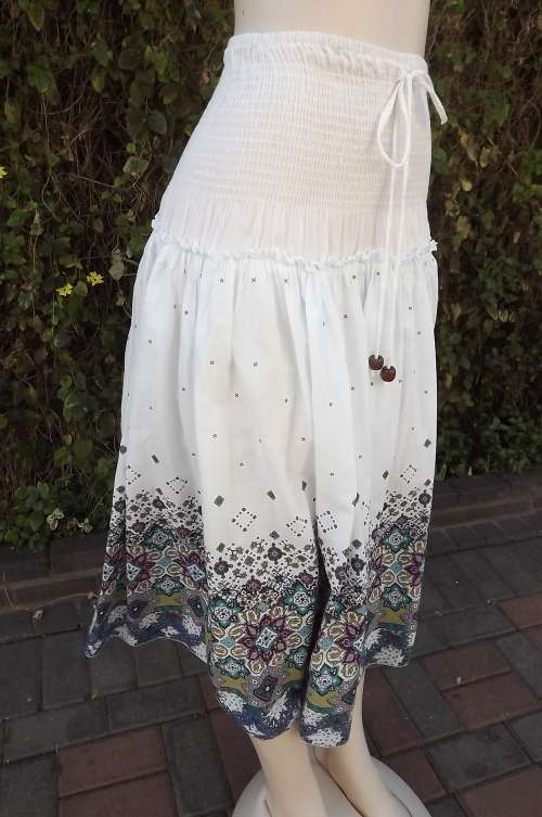 White tiered skirt with purple/blue printed border.Elasticated hips and middle.Size 34/10