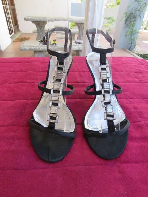 Pair of black high heel sandles with ankle straps in size 5 by FOSHINI GLAMOUR
