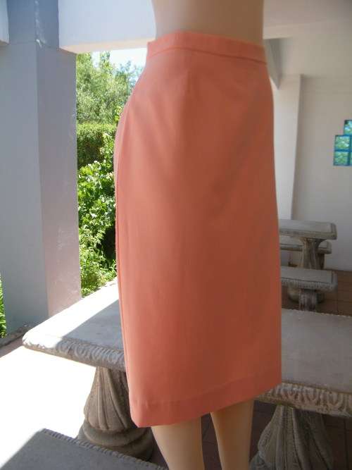 Pencil skirt in peach colour made by owner.Size 42/18.Zip at back with slit.Good condition