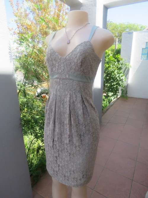 Delicate and lacy trend setting cocktail dress in very soft turquoise colour.Size 32/8