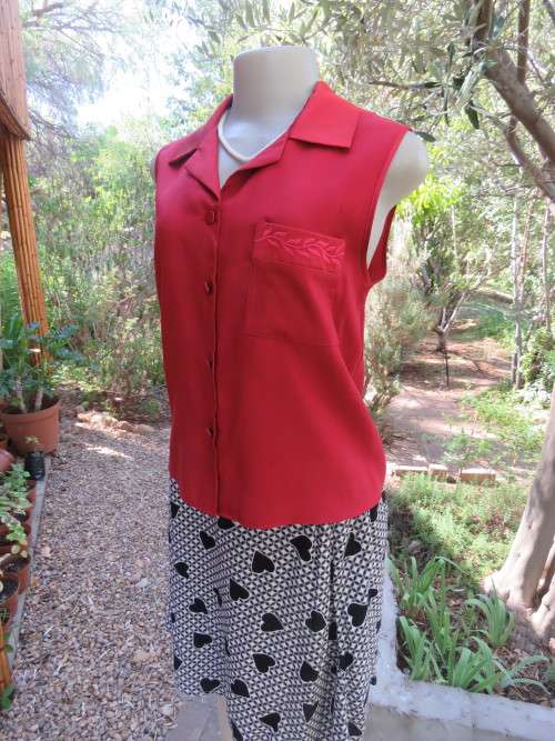 Red silky sleeveless button down top with open collar.Size 35/11 by WOOLWORTHS.