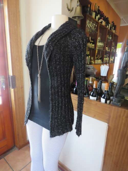 Black acrylic knit long sleeve cardigan .Knitted in double rib stitch.Size Small 32/8.Good condition