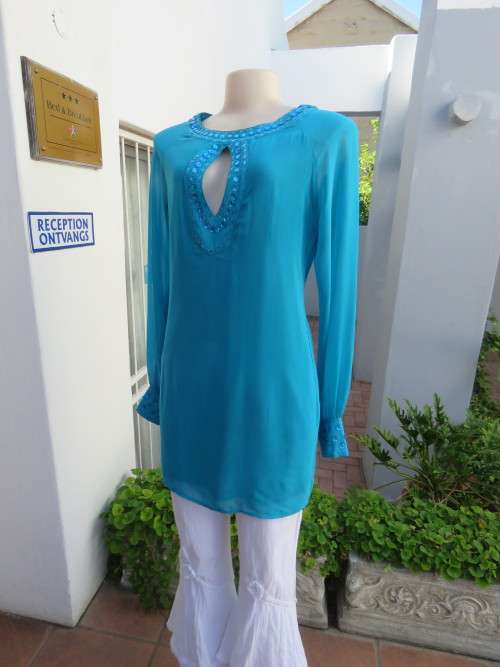 Stunning long sheer polyester top in turquoise .Fully lined.Size 34/10 by TSEGA.Long cuffed sleeves