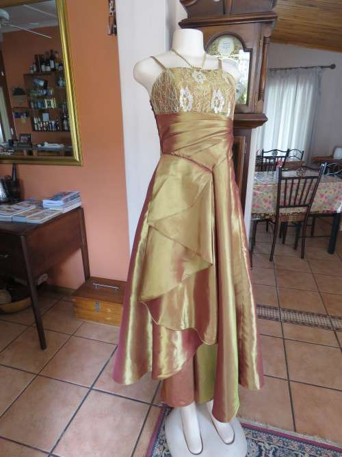 Gleaming gold colour long evening dress with acrylic lace bodice front.Size 36/12.Good condition