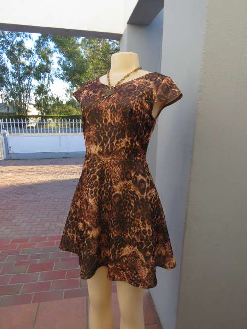 Edgy animal print short dress by RT. Sexy 34 to 36. Low back.In stretch polyester.As new.