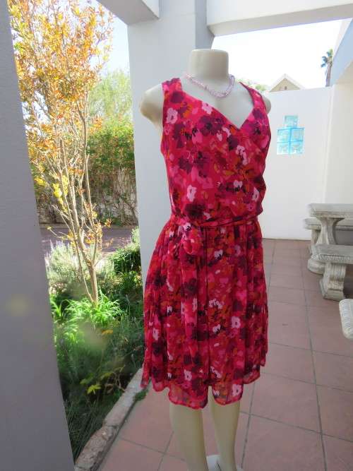 Eye catching bright coloured floral dress in size 42/18 by 'IMAGE' with wide fabric slash.As new.