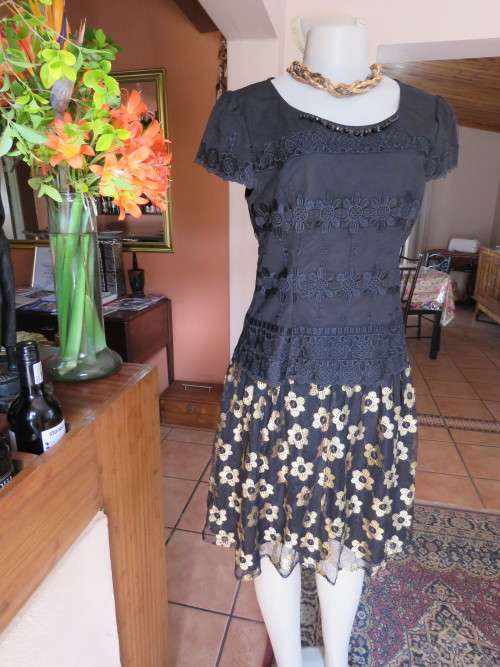 Fabulous 2 piece black /gold outfit in 36/12.Lined skirt with black/gold lace overlay.New item.