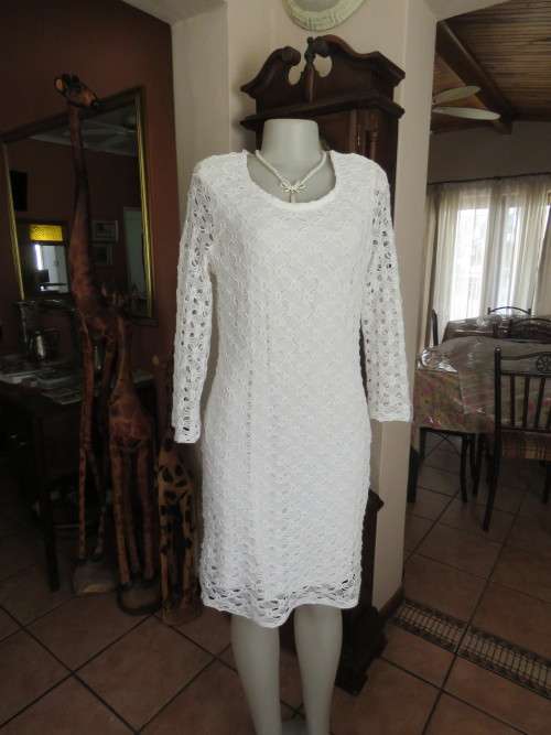 White polyester stretch shift dress with a lace overlay.Size 36/12.Long lace sleeves.Good condition