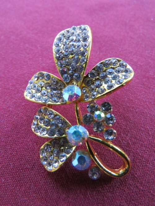 Fab gold toned brooch with lots of tiny faux diamond stones on leaves.New.