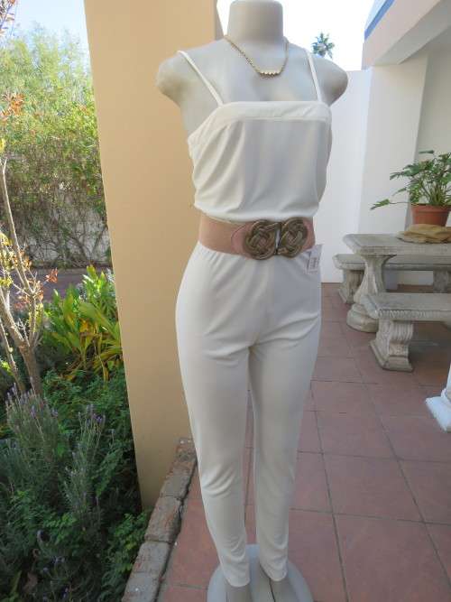 Soft cream stretch polyester jumpsuit in size 32/8 by 'TREASURES'.Used but in good condition.
