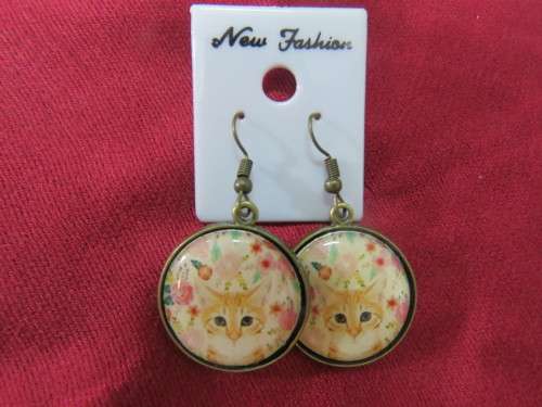 Pair of pierced drop earrings with porcelain raindeer fronts,round design with brass backing.New.
