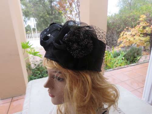 Black pillbox hat decorated with sequins,chiffon and netting.New condition.