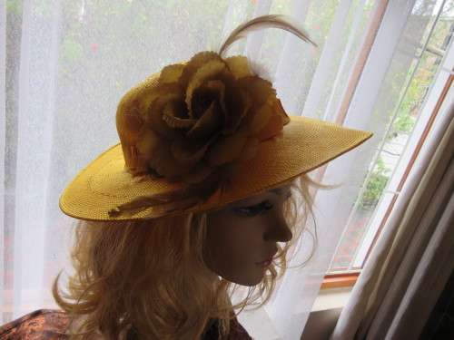 Vintage hat in light orange colour with band and flower.Good condition.