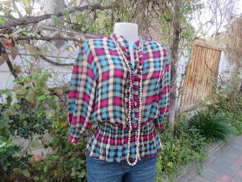 Soft,silky peplum top in purple,blue,beige and brown check.Size 38/14 in polyester.New cond.