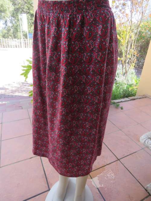 Paisley patterned maroon skirt in size 40/16 with pleat at back.Used but good for everyday wear.