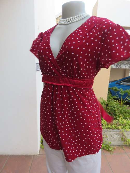 Dark red and white polkadot top in stretch polyester in size 34/10.  By "JH" In good condition.